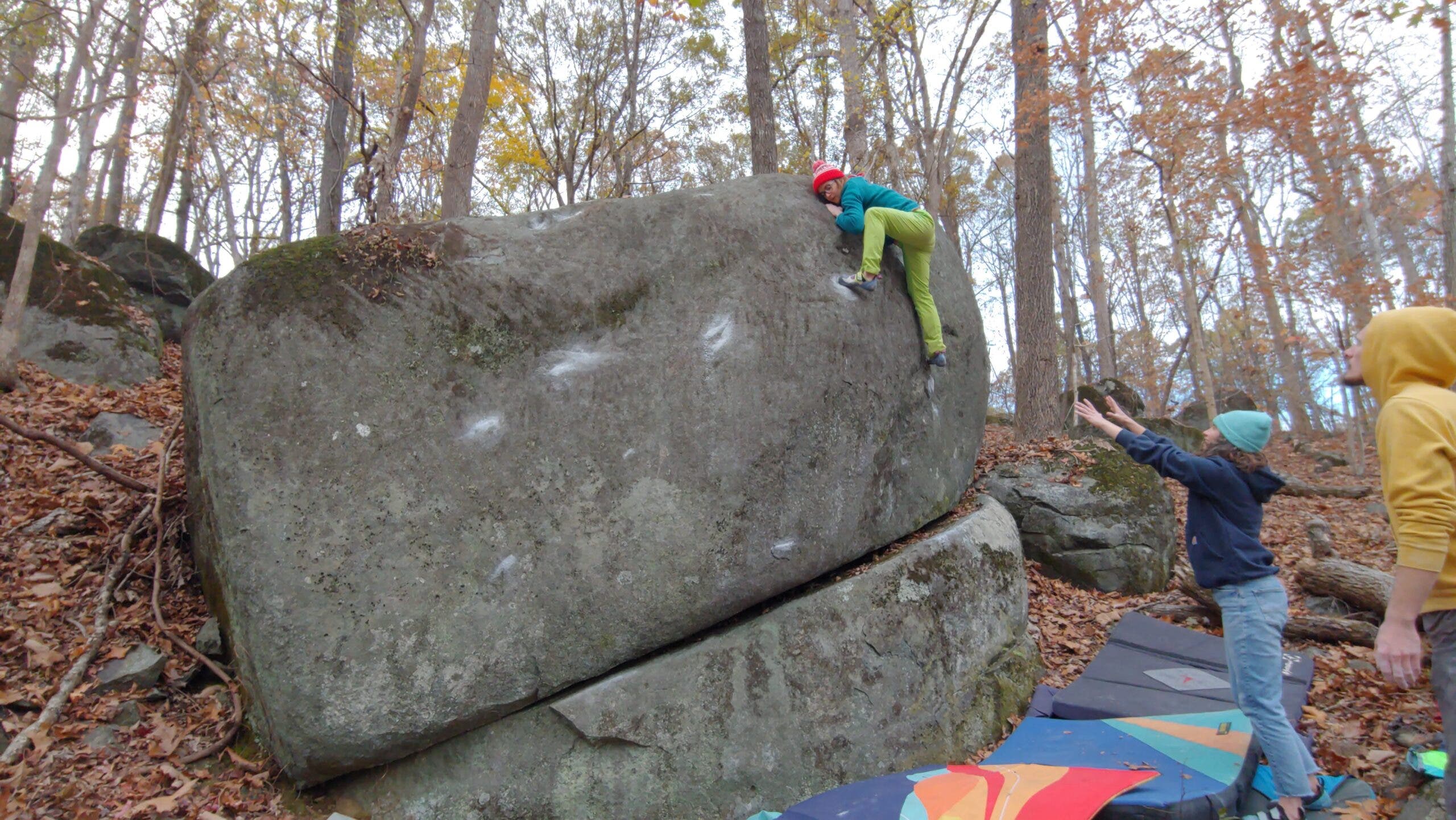 A climber topping out a very sloping block at the Asheboro Boulders.