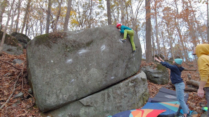 A climber topping out a very sloping block at the Asheboro Boulders.