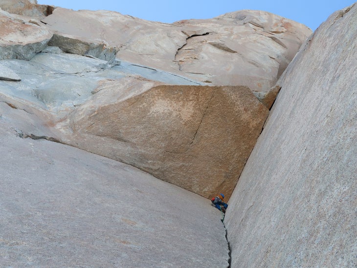 Luka Krajnc leads an aesthetic dihedral pitch that cuts right around the huge roof on Pot, a new route on Poincenot in Patagonia.