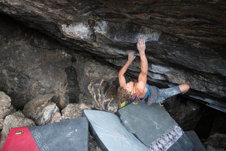 A climber sending one of the boulders destroyed by the 2022 landslide.