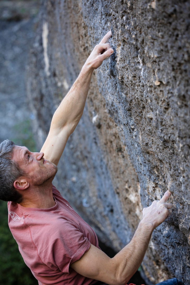 Bolger grimacing as he moves through mono-pockets high on his new 5.15b, E.L.L.I.E.