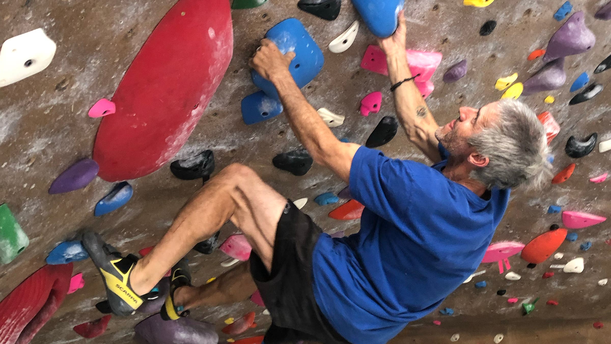 Climbing gear tester Matt Samet tests the Scarpa Arpia V shoes on indoor rock wall