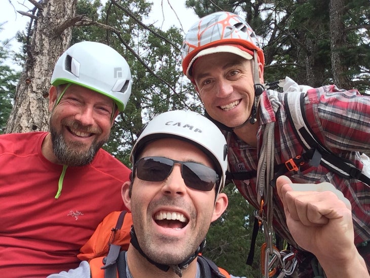 Rob Coppolillo climbs with two male friends.