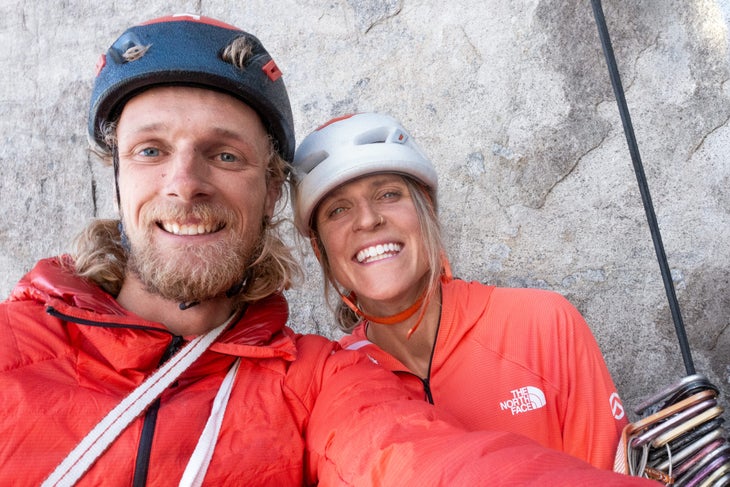 Martin Feistl and Fay Manners smile at a belay in Greenland.