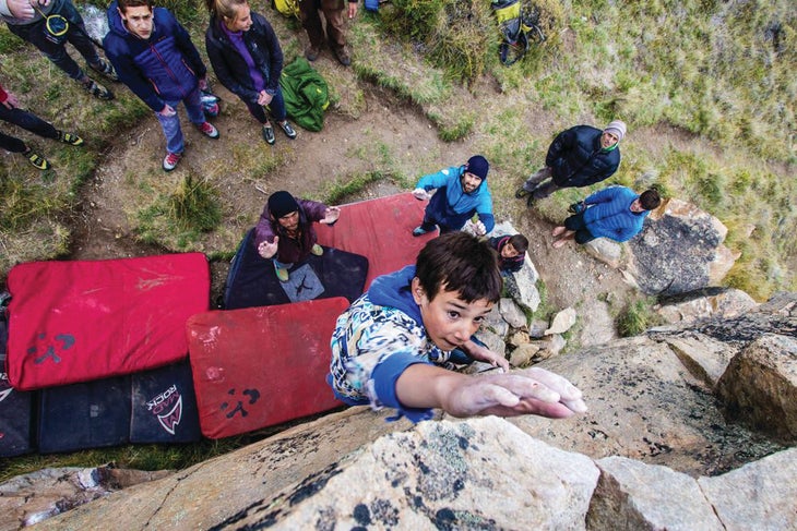 Tomas Odell reaches for the finishing hold of an unnamed V4 boulder in his hometown of El Chaltén.