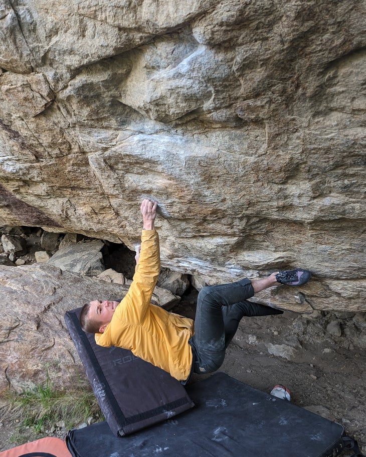 Nat Bailey climbs overhanging granite boulder in Patagonia.