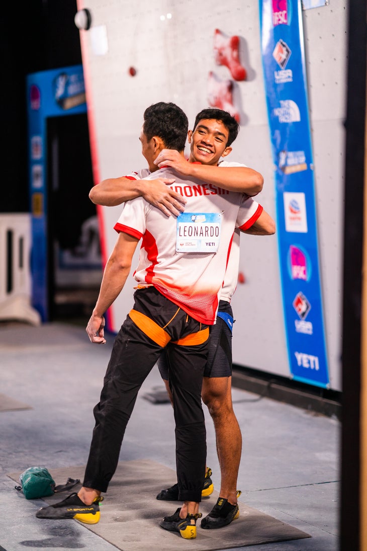 Two speed climbing competitors hugging