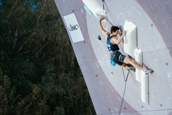 USA Olympian Jesse Grupper climbing on a steep wall in an international competition.