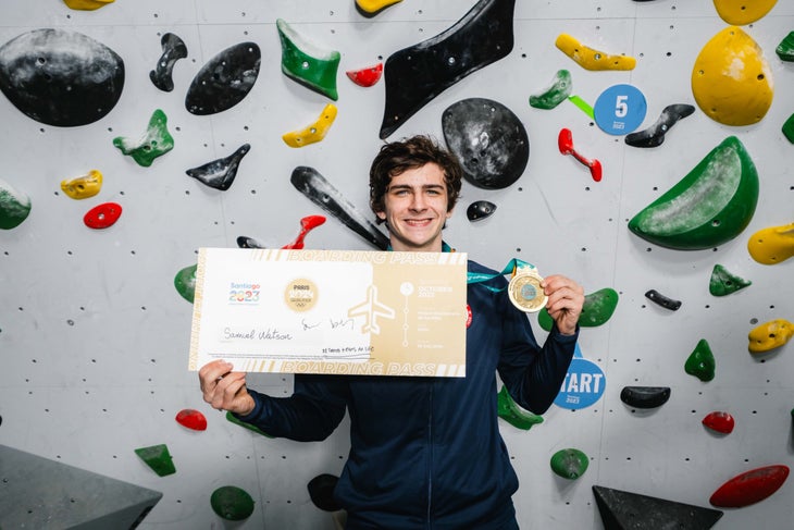 Sam Watson holding his Pan American Games medal and olympic ticket