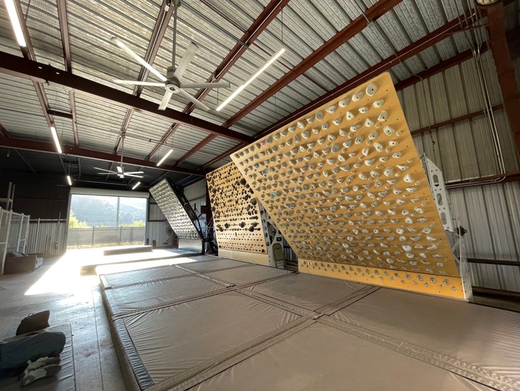 A climbing gym space with three LED systems boards