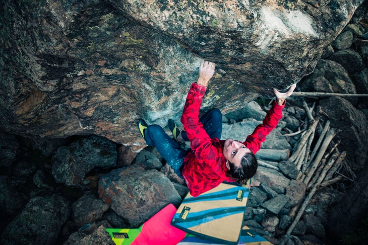 Sam Weir in a red shirt on the upper moves of The Ice Knife (V14/15).