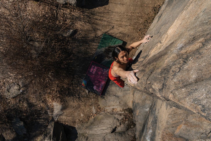 Nonbinary climber Sunna Shin climbs Cat Arete (V0) in Central Park, New York, NY.