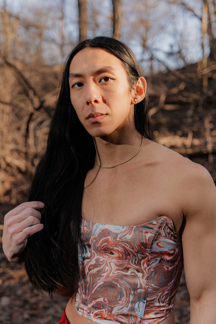 Sunna Shin poses for a unsmiling portrait in Central Park, New York, NY.