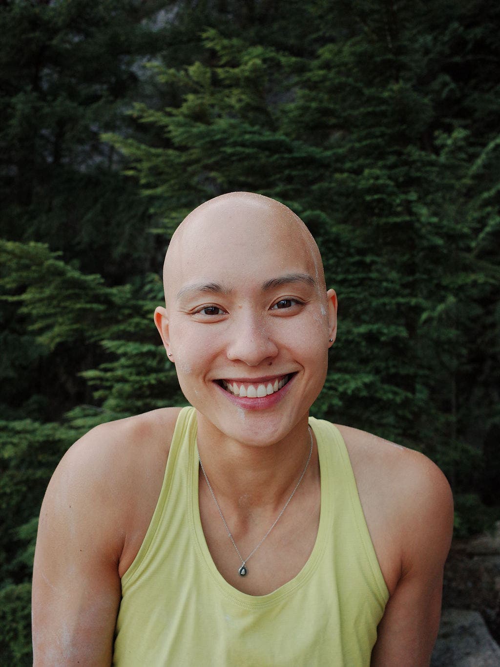 Climber smiles in a forest in Squamish, BC.
