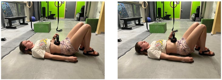 Woman lays on floor in a gym, with a kettlebell on top of her stomach to add resistance to her diaphragmatic breath training.