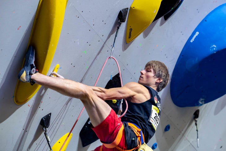 Alex Megos toehooking in the Iati climbing shoe on a lead competition route.