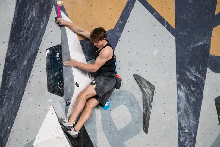 Colin Duffy wearing a pair of Evolve Zenit Pro climbing shoes on a technical competition boulder