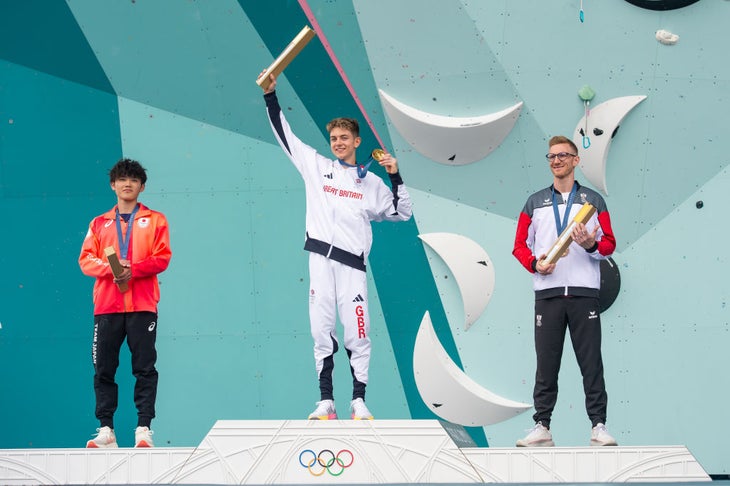 Gold medalist Toby Roberts of Great Britain (C), Silver medalist Sorato Anraku of Team Japan (L) and Bronze medalist Jakob Schubert of Team Austria (R) celebrates on the podium during the Men's Boulder Final Ceremony.