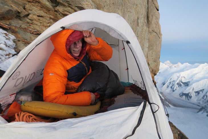 Tom Livingstone in a tiny bivouac spot high on Gasherbrum III