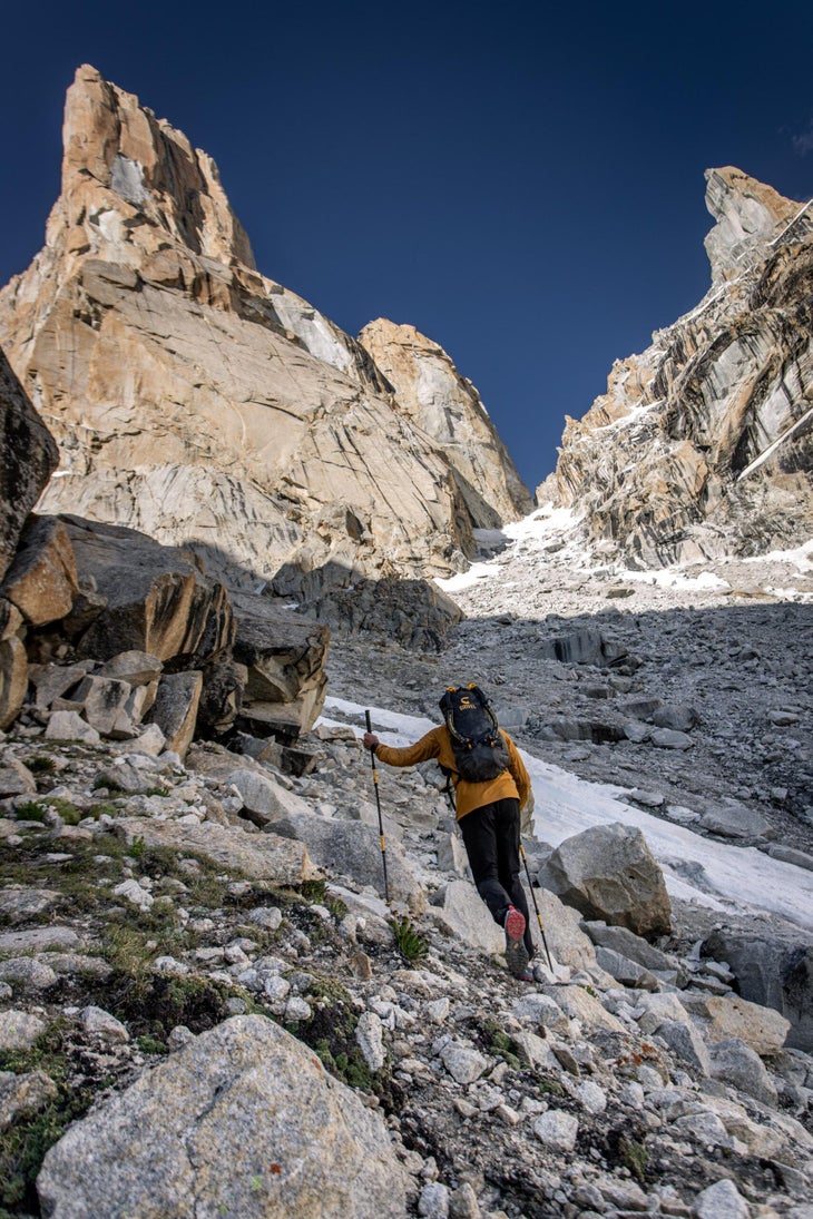 Climber hikes to the base of a big wall in Pakistan.