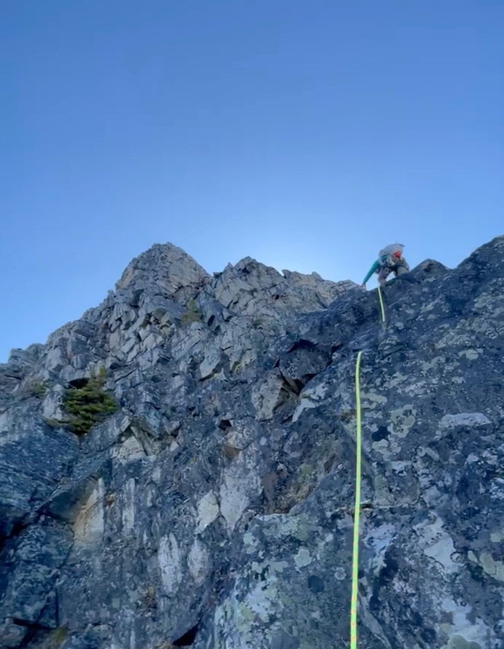 The author testing the Blue Ice Stache UL pack on an alpine climb for this review.