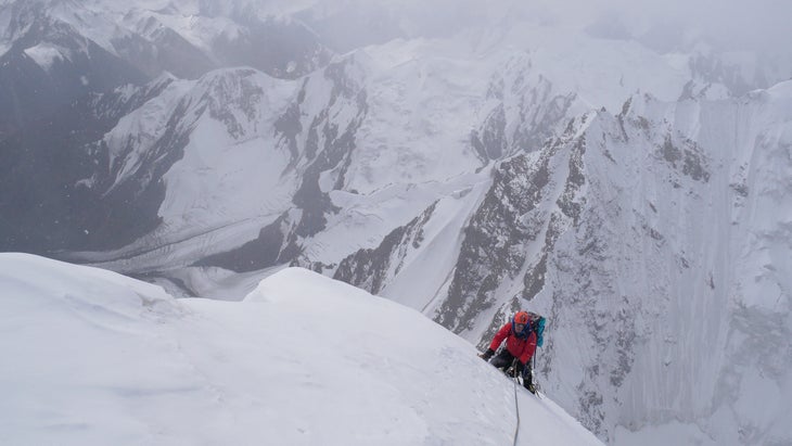 British Alpinist climbs to the summit of an unclimbed peak.