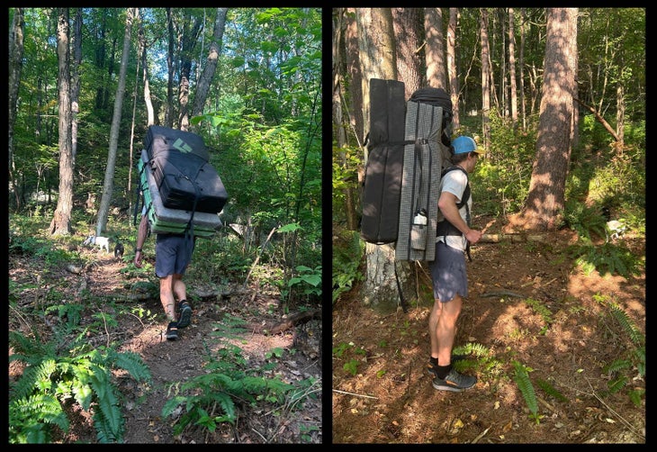 A male climber carrying two bouldering pads. One of them is the Erratic Crash Pad.