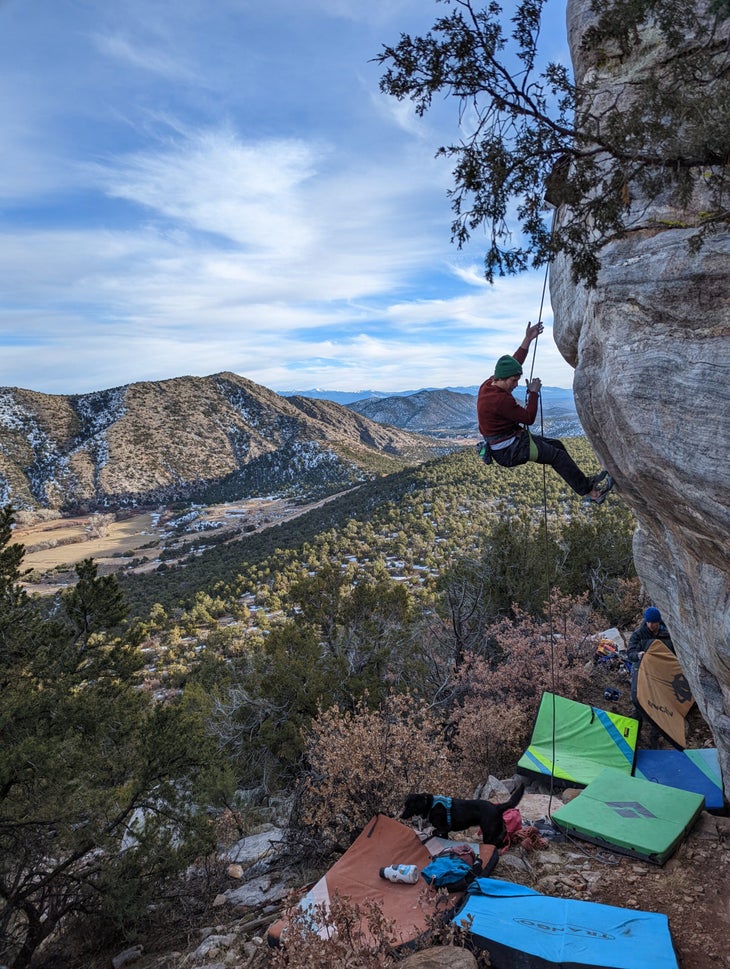 The author hanging on a rope on a highball boulder.