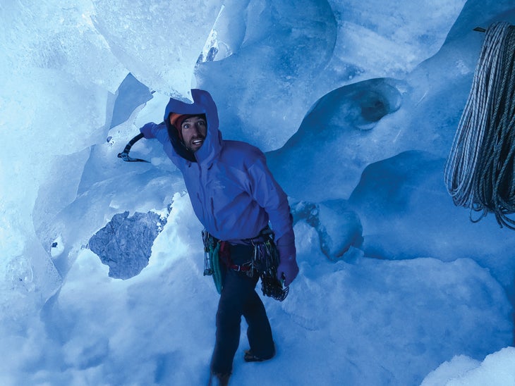 Alik Berg stomps out a tent platform inside an ice cave at the team's first bivouac.