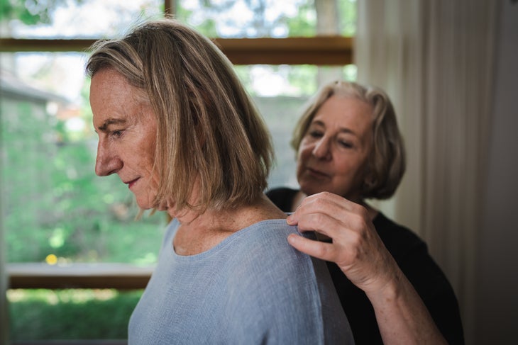 Jamie Logan gets dressed beside her wife.