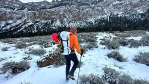 A man walking to an ice climbing route