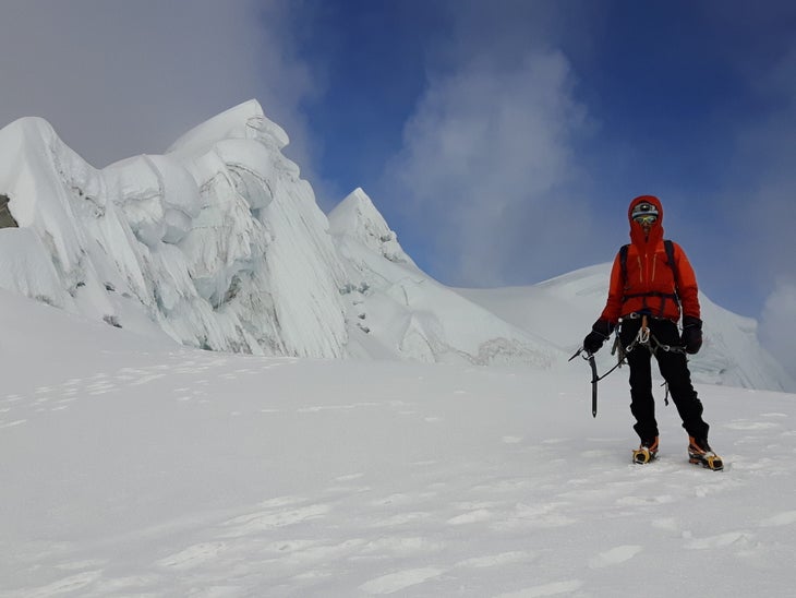 Fillipo Zanin on Peruvian summit surrounded by snow.