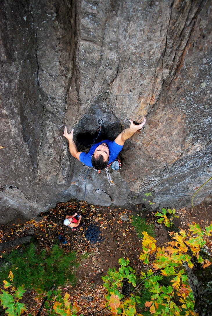 A top-down shot of a male climber on a 5.10b in Merriam Woods