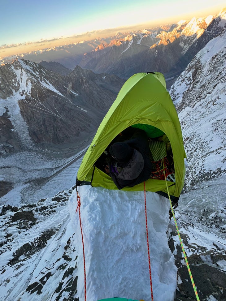 A tent perched on a 2-foot wide cornice with thousands of feet of air below.