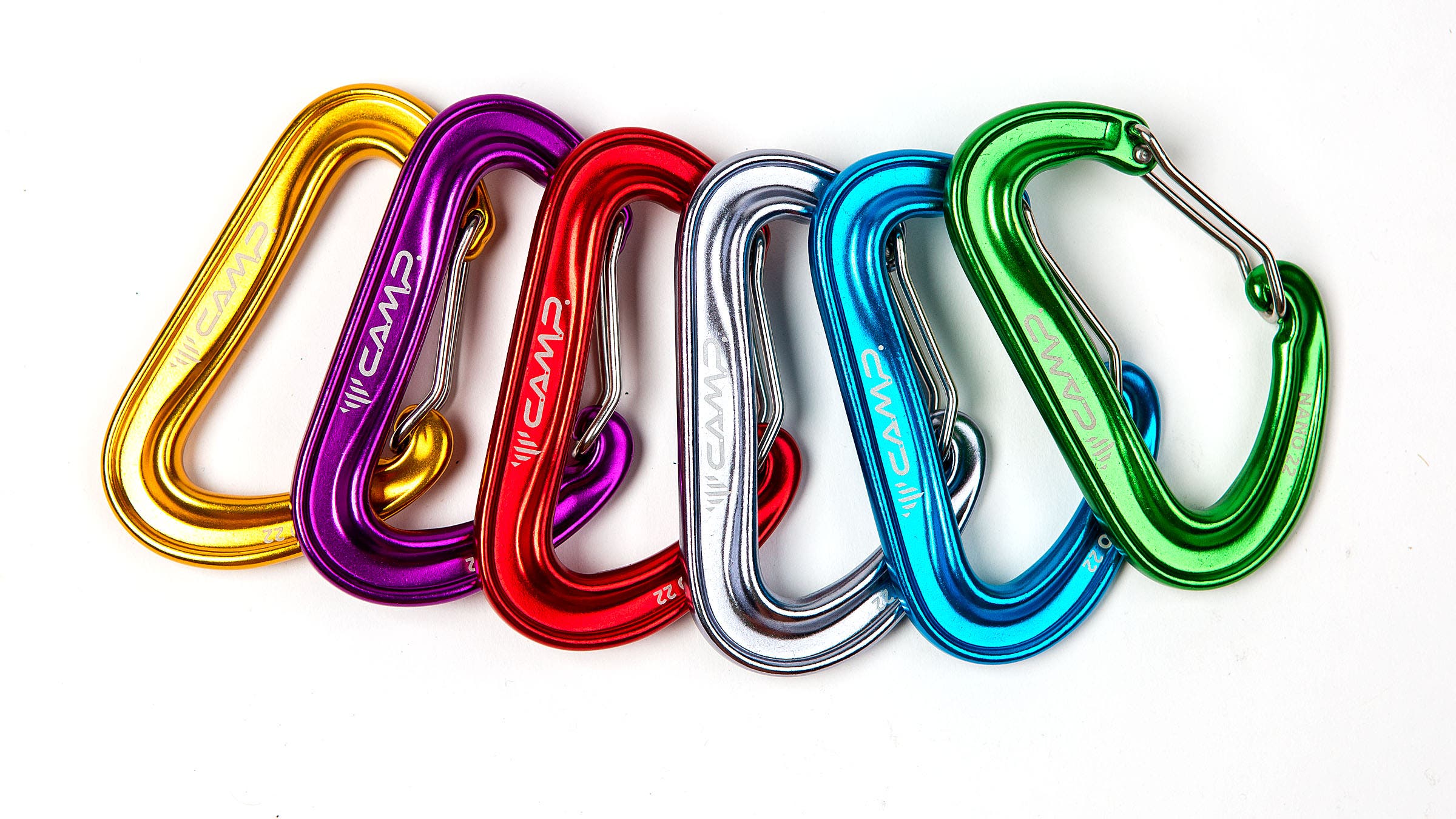 Six colorful climbing carabiners on a white background.