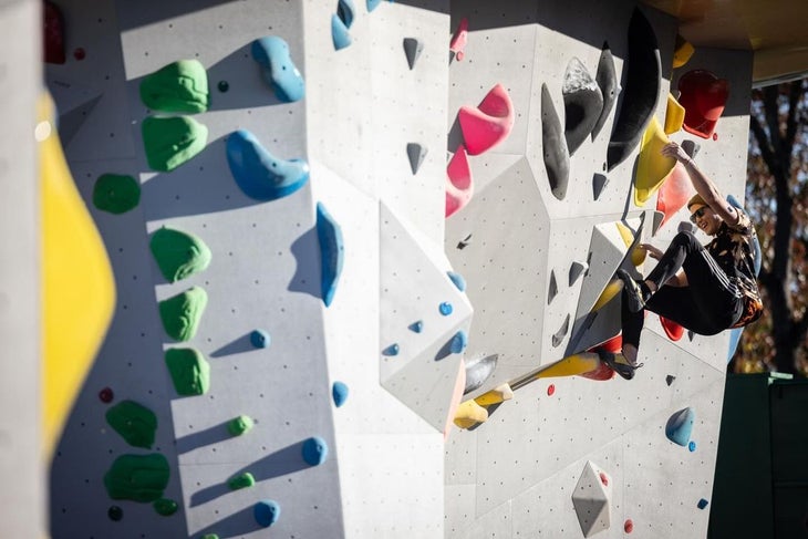 A male climber sending a boulder in the Boyce Bouldering Park, in Allegheny County