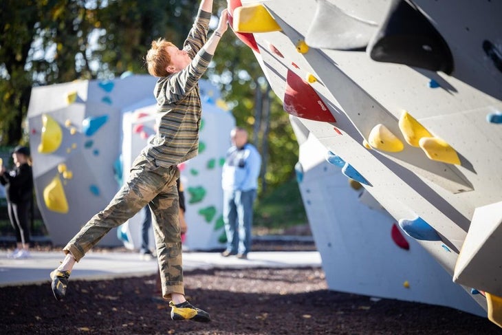 A man dynoing at the Boyce Bouldering Park