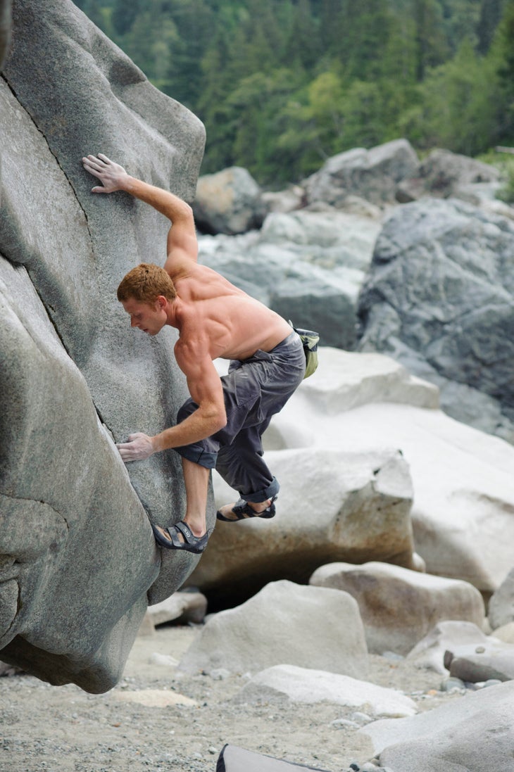 Johnny Goicoechea looking very strong as he stems up a technical granite river boulder.