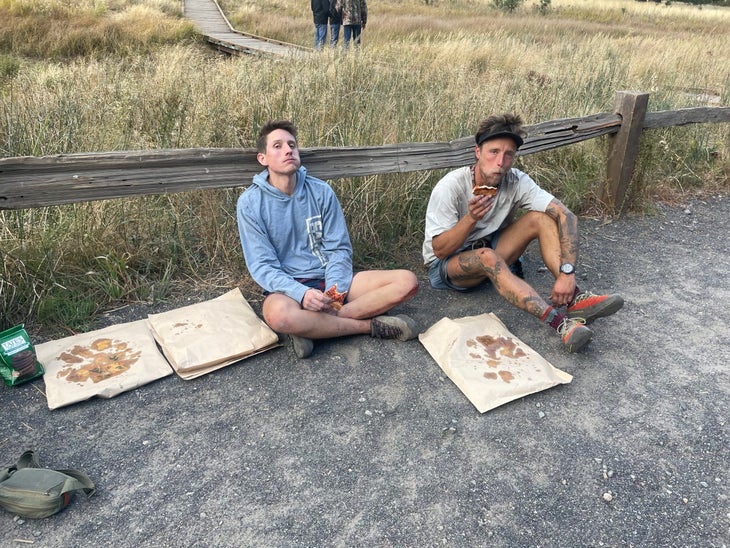 Michael Vaill and Tanner Wanish eating pizza during their 24 hour effort.