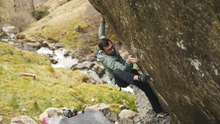 Wil Bosi heel hooking and moving his hand into the undercling on Spots of Time, a V17 in the Lake District