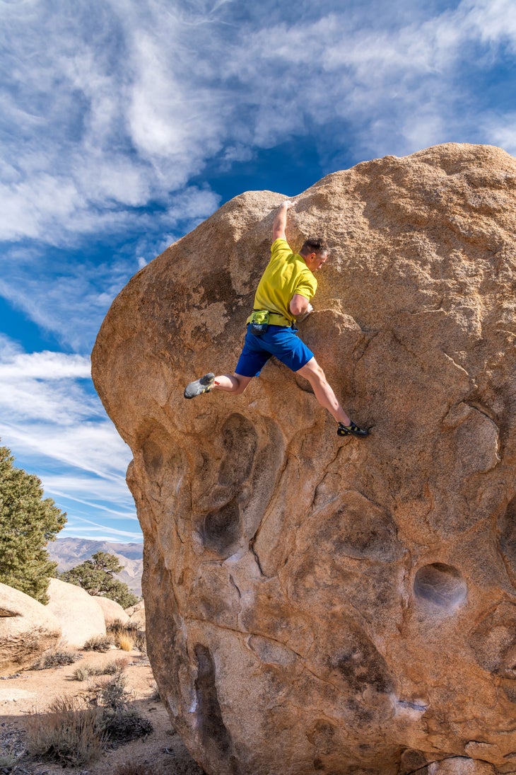 A man bouldering in the foothills of the Sierra.