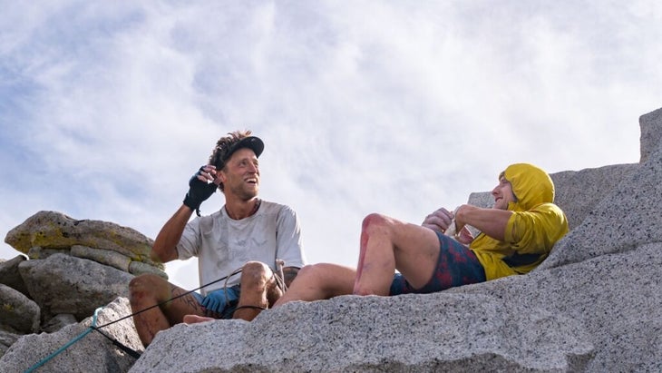 Michael Vaill and Tanner Wanish sitting on the top of Half Dome, having just completed the Yosemite Quad.