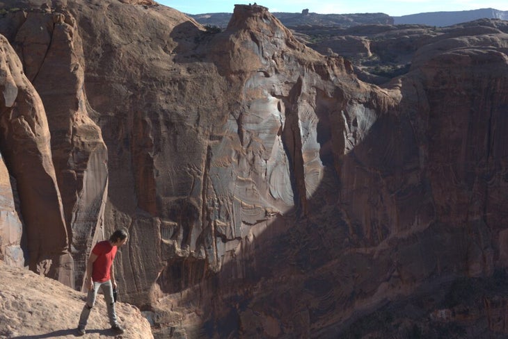 A man looking over the edge of a cliff