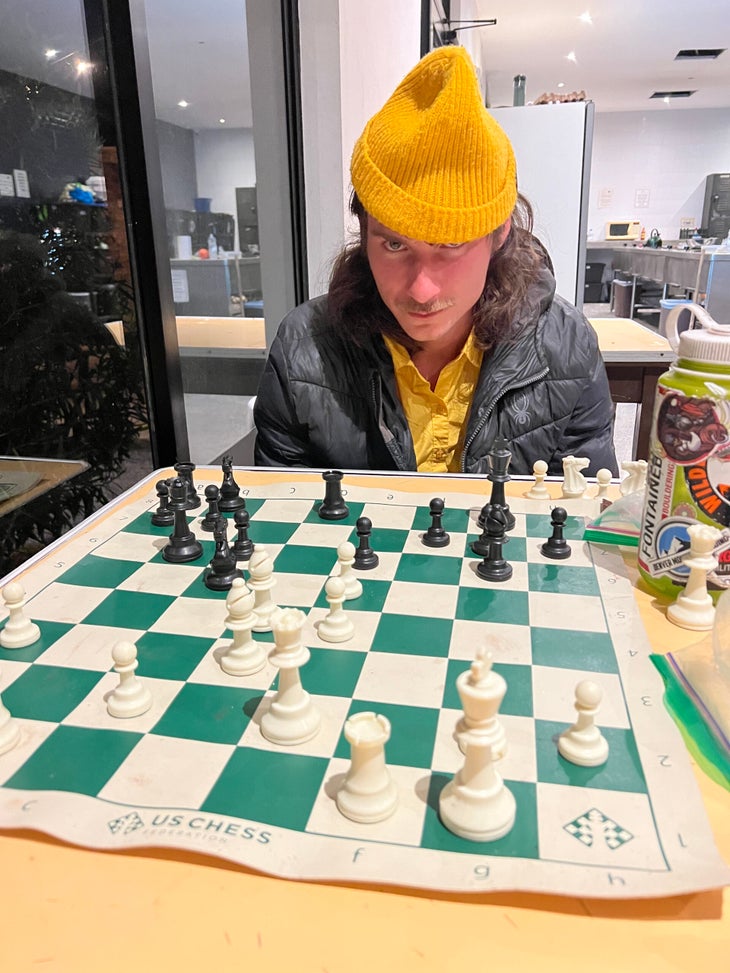 Matt Richard playing chess (and looking a bit unhappy about it.)