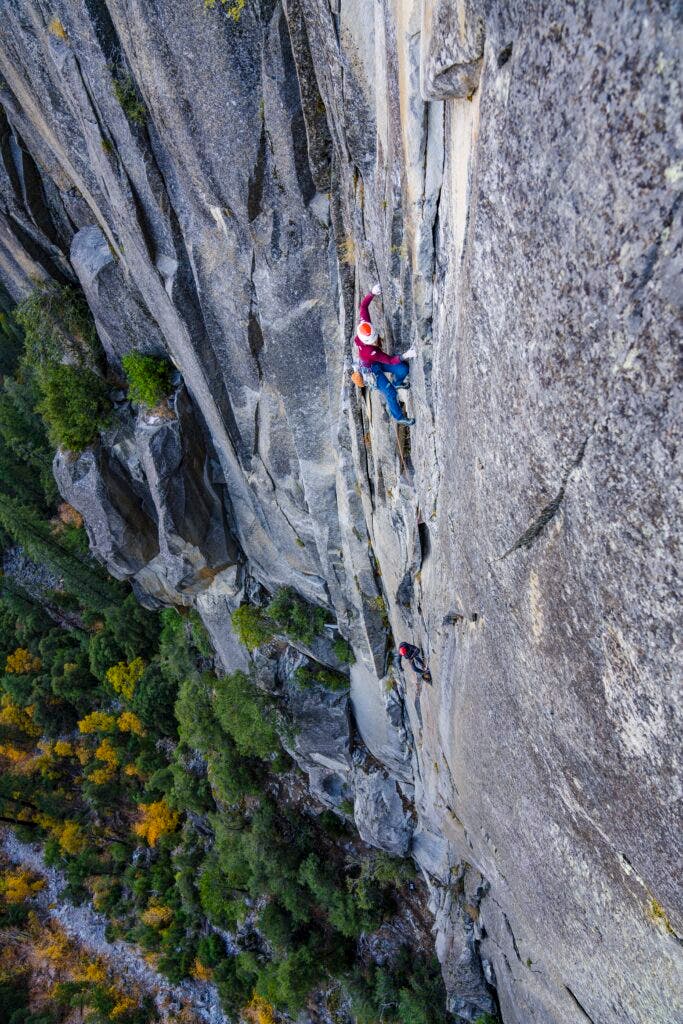 Emily Harrington on a big wall in Yosemite with trees below 