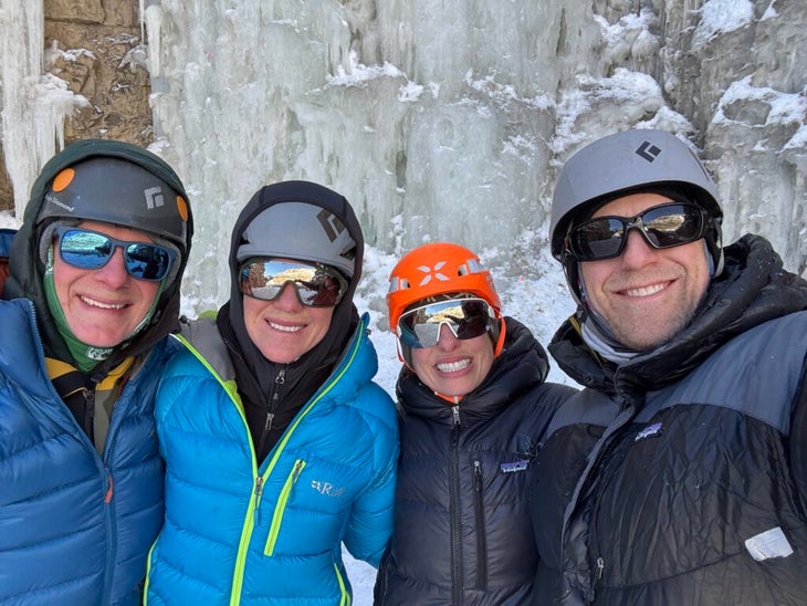 four climbers in down jackets 