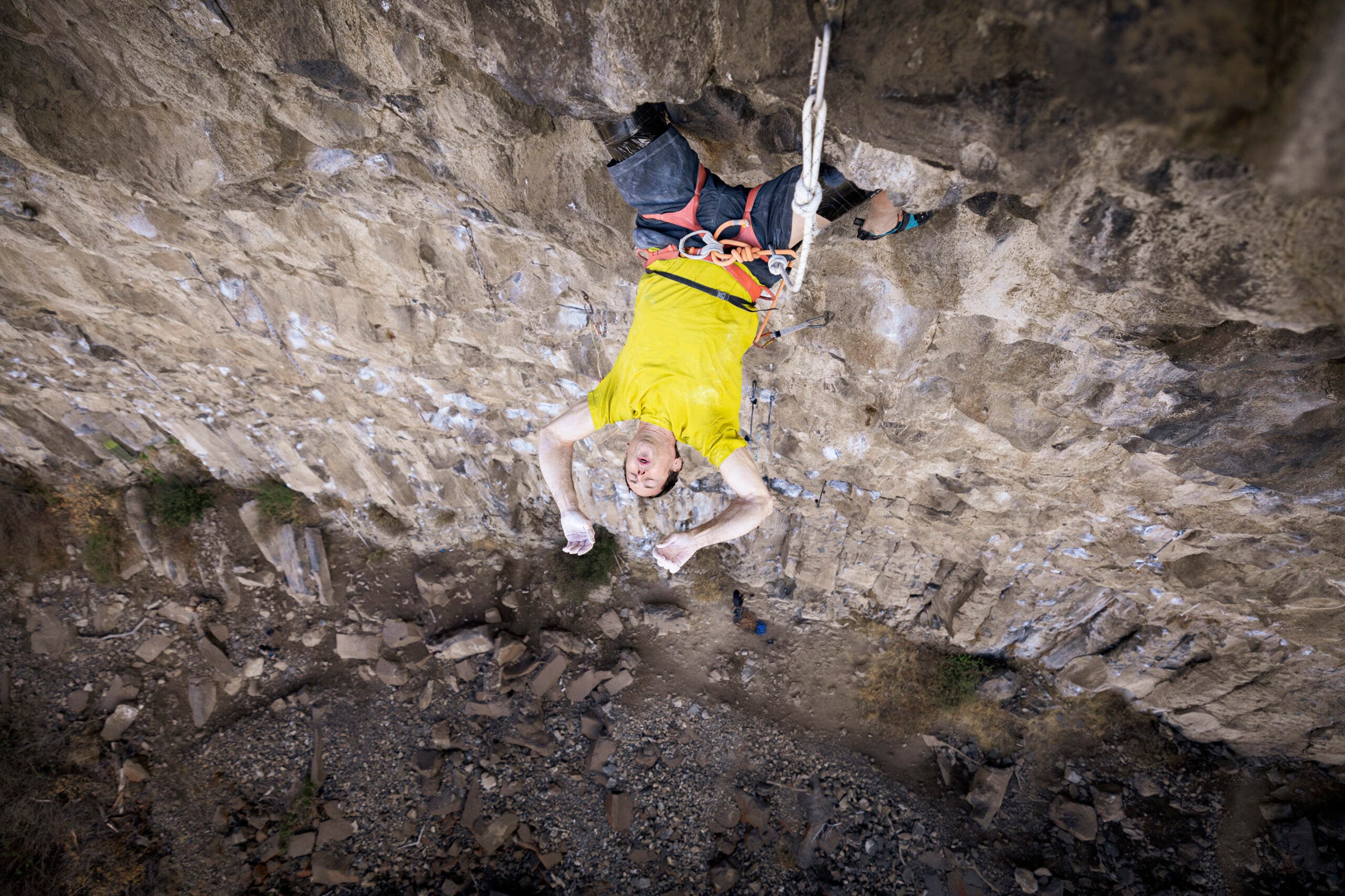 best climbing photos of 2025: a climber rests on his knees on a steep wall