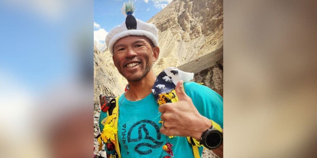 Kazuya Hiraide smiles, giving a thumbs up, while in basecamp after a climb.