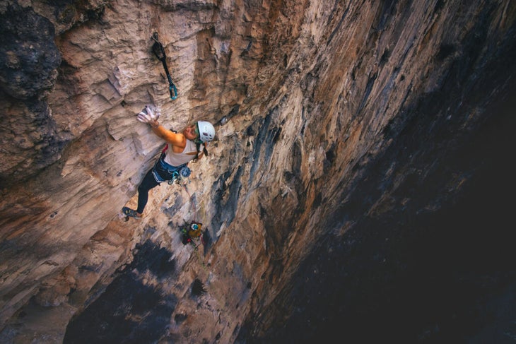 A woman climbing Belly of the Beast