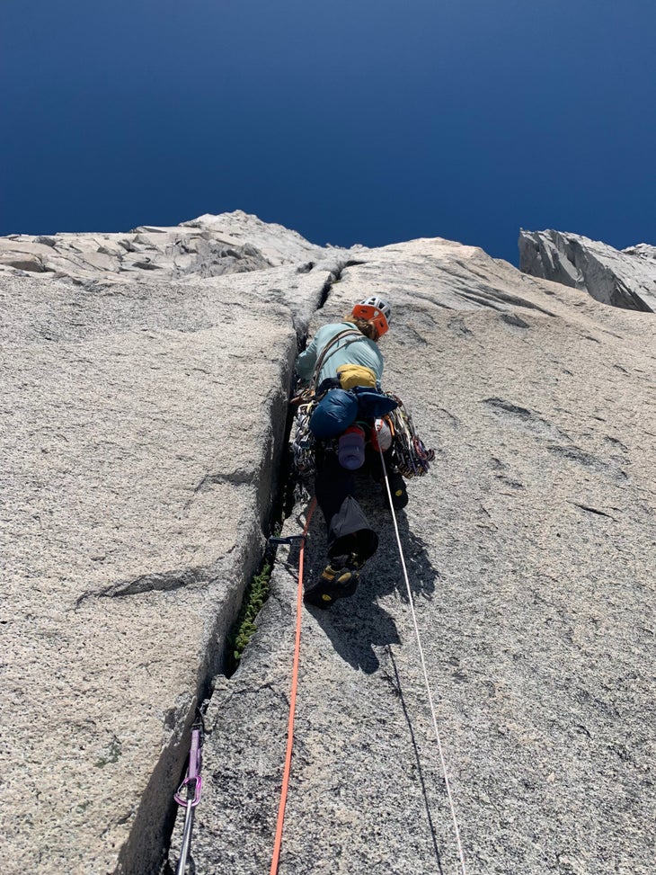 Woma climbs steep granite crack in Patagonia.